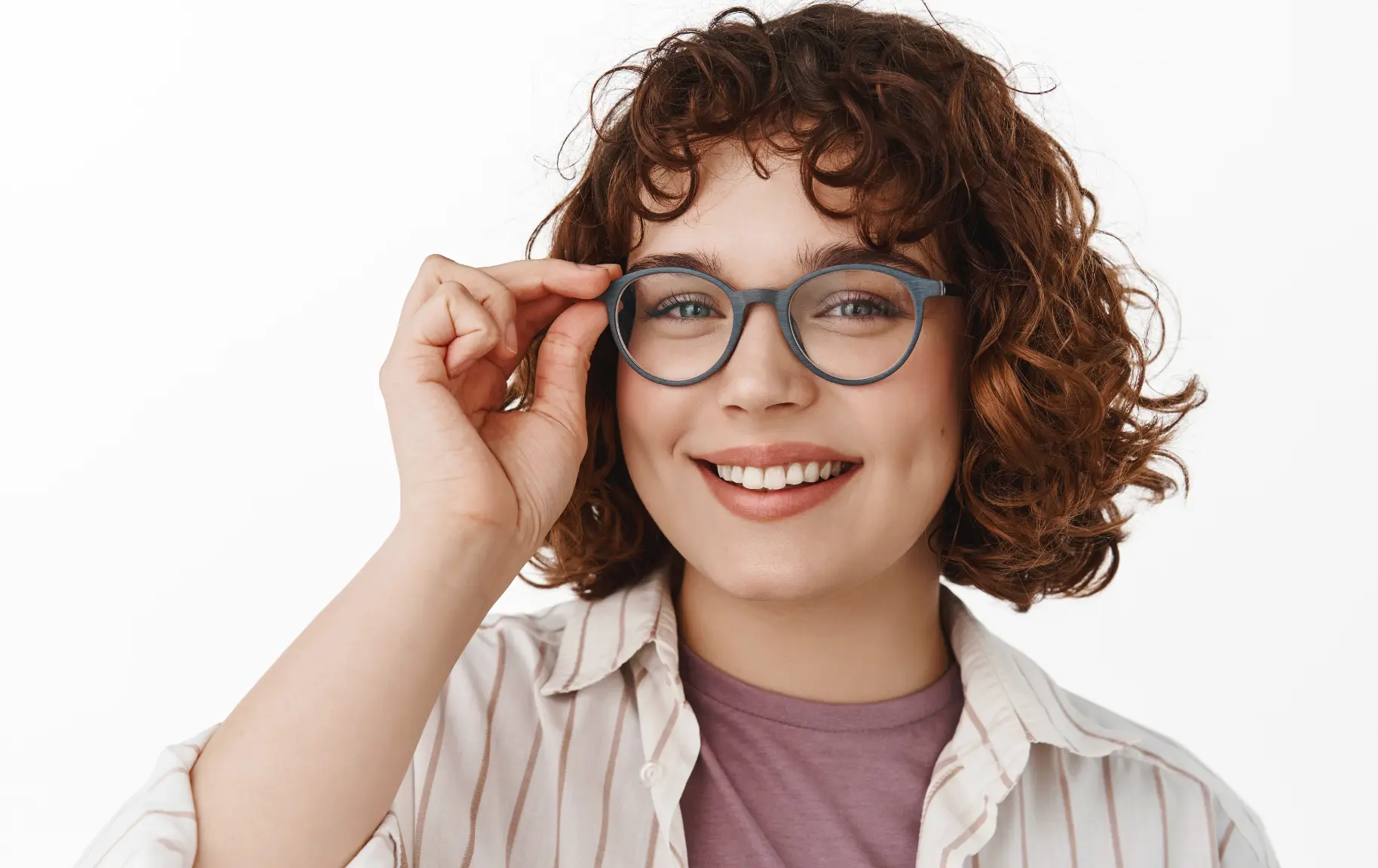 Smiling woman adjusting her prescription glasses