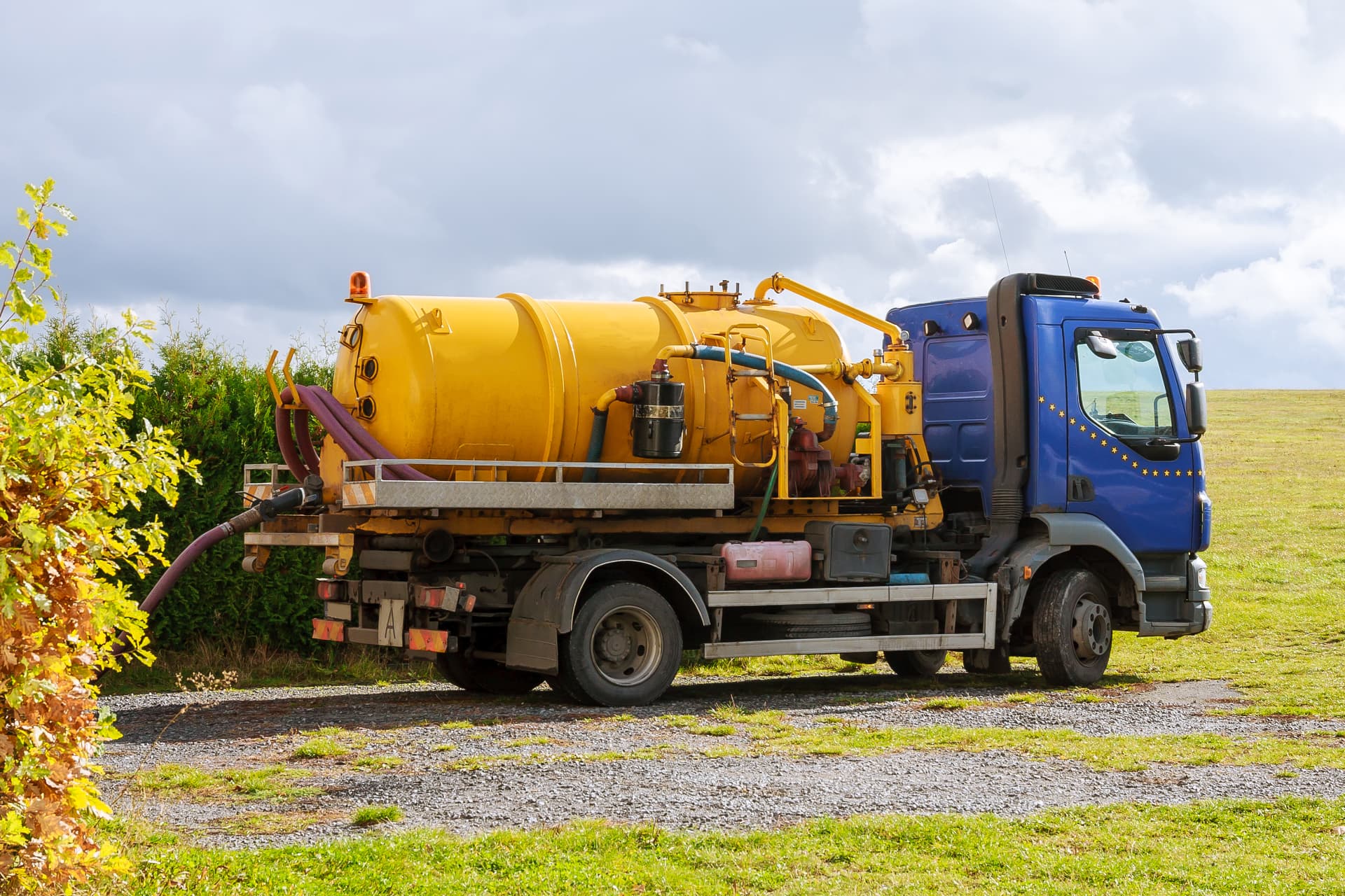 Yellow mobile water treatment tanker truck at a riverside site
