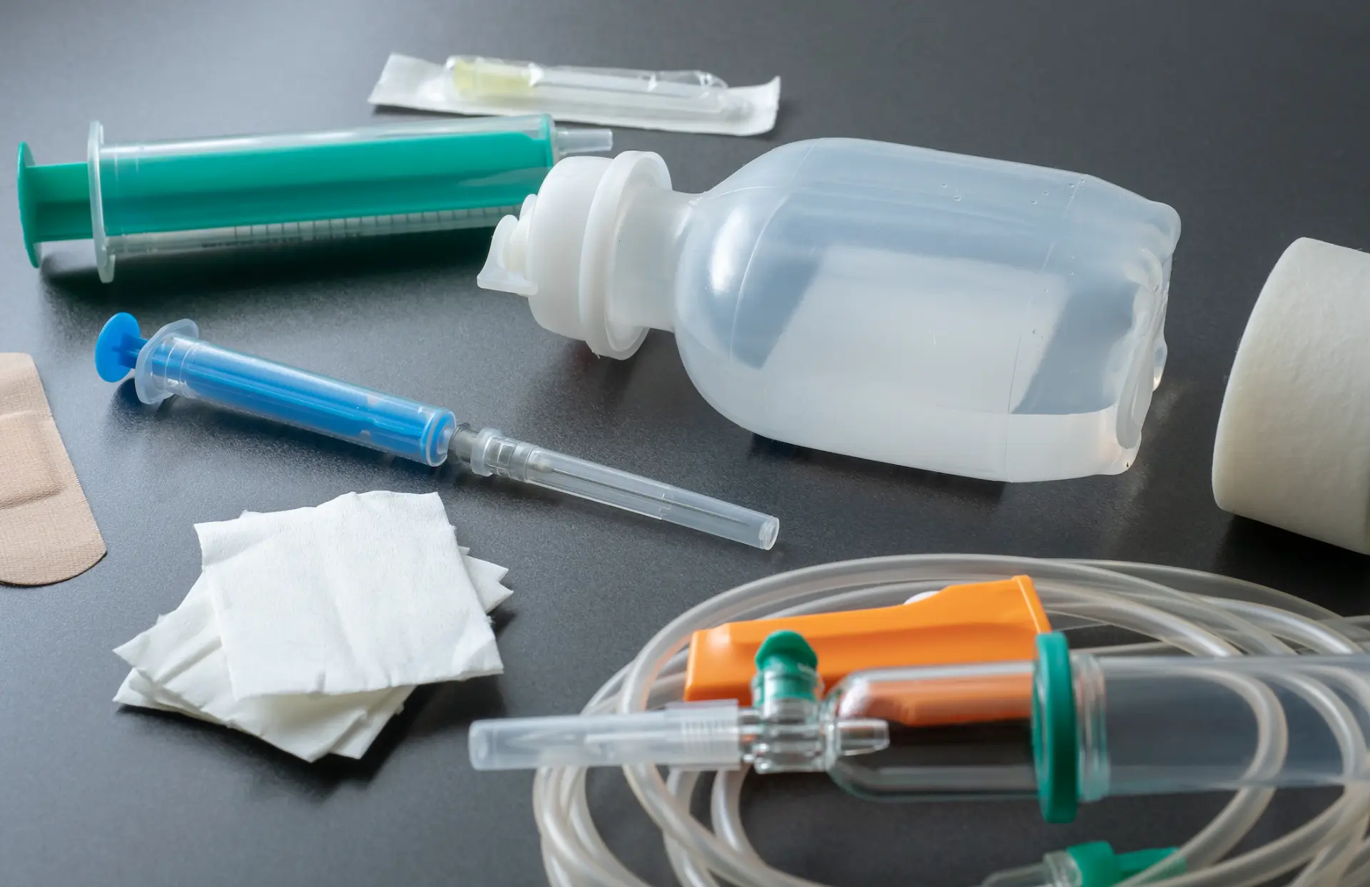 Medical syringes and infusion set on a clinical surface