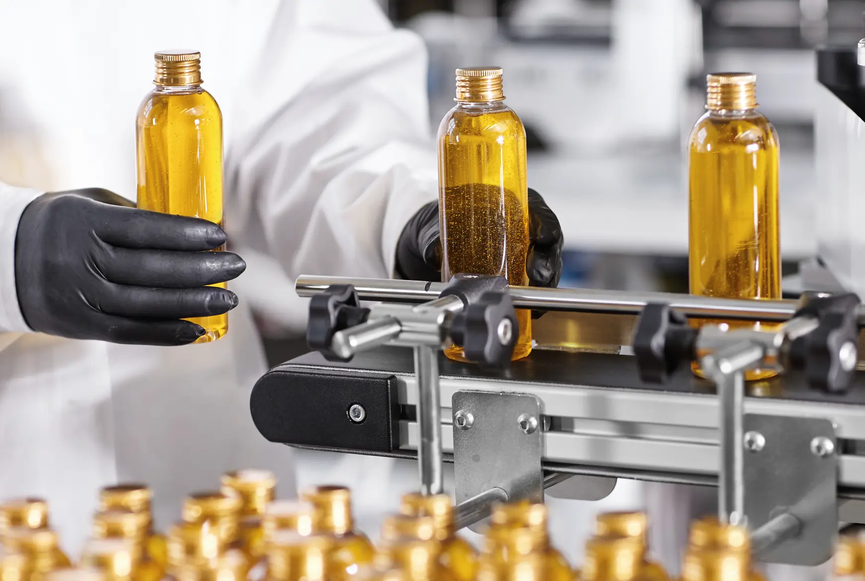 Amber-filled bottles moving along a production conveyor